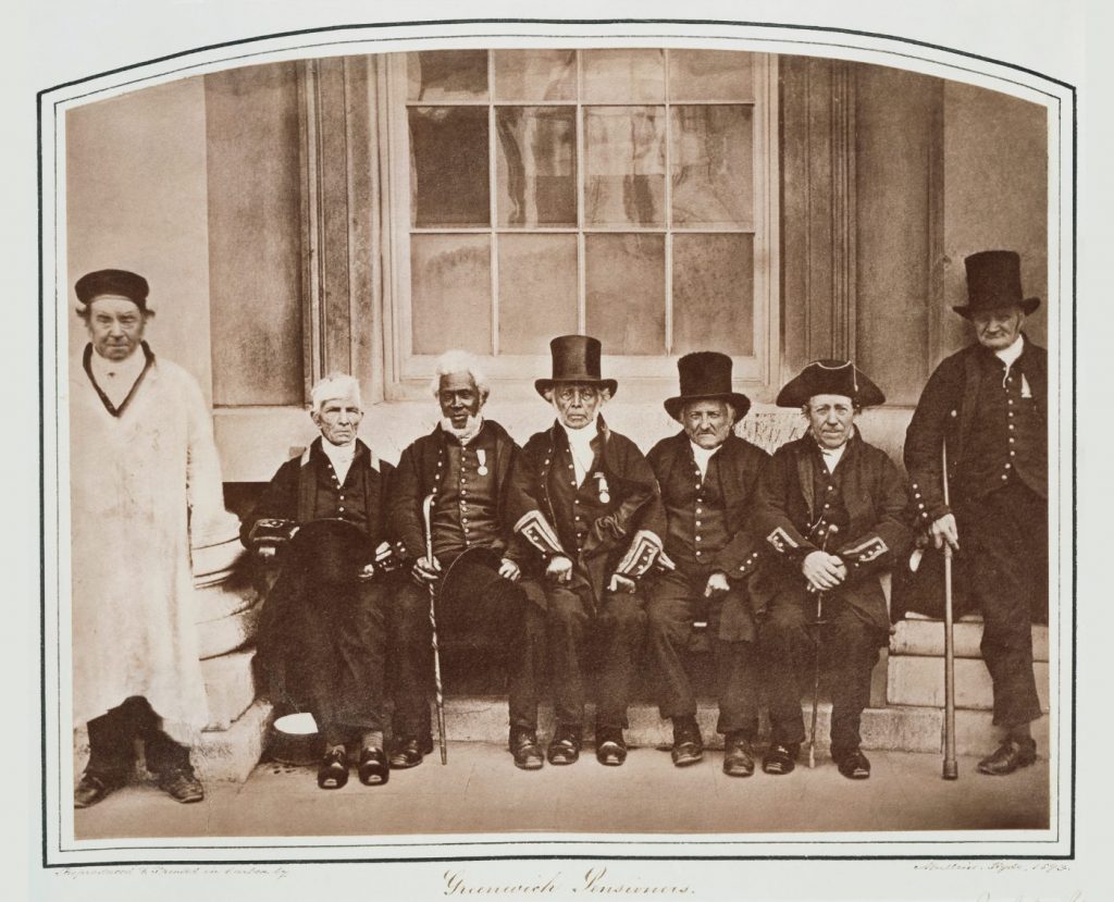 An old photograph depicts six pensioners wearing their recently awarded medals outside the Royal Hospital for Seamen. One of them is a Black pensioner.