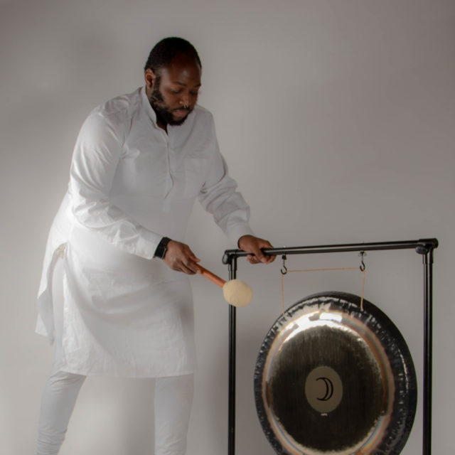 Junior Valentine using a gong