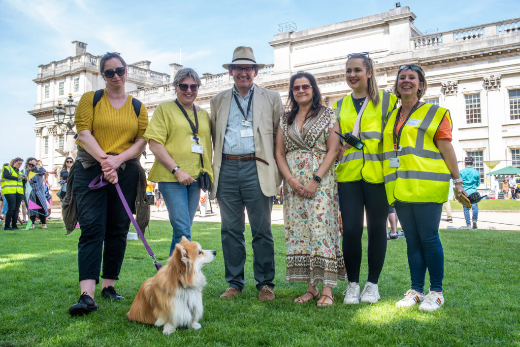 A group of people standing in front of a dog