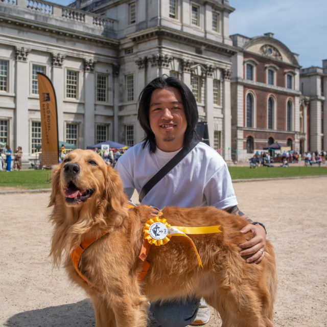 a person with a dog in front of a building