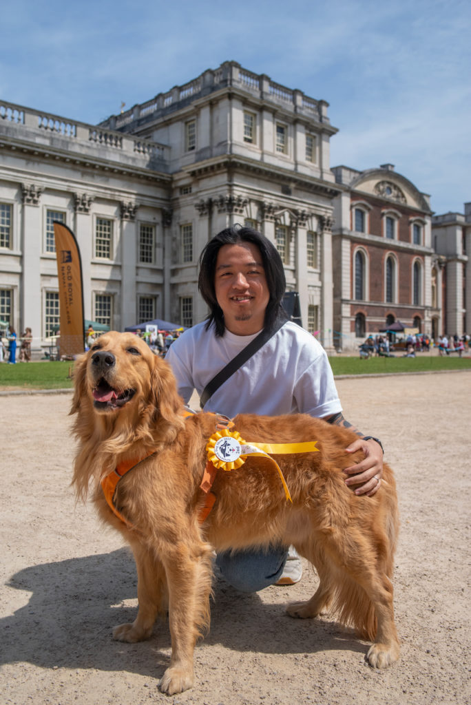 a person with a dog in front of a building