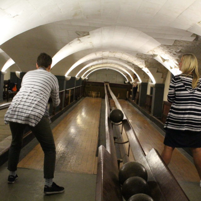 Visitors playing on Old Royal Naval College Skittle Alley